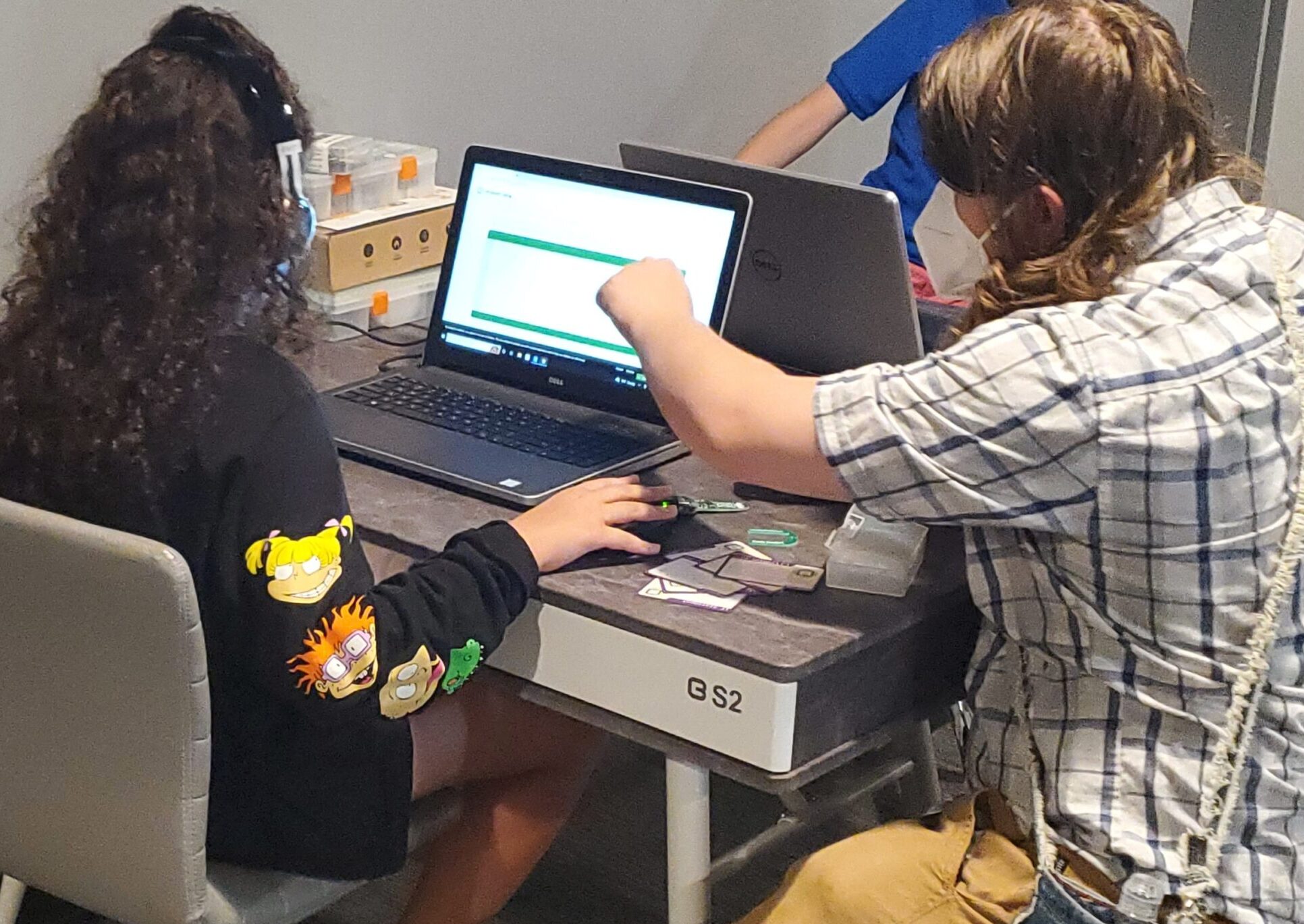 A TECH Unleashed member receives guidance on a computer program.